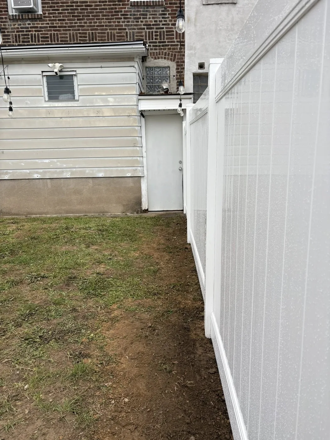 White vinyl privacy fence side yard